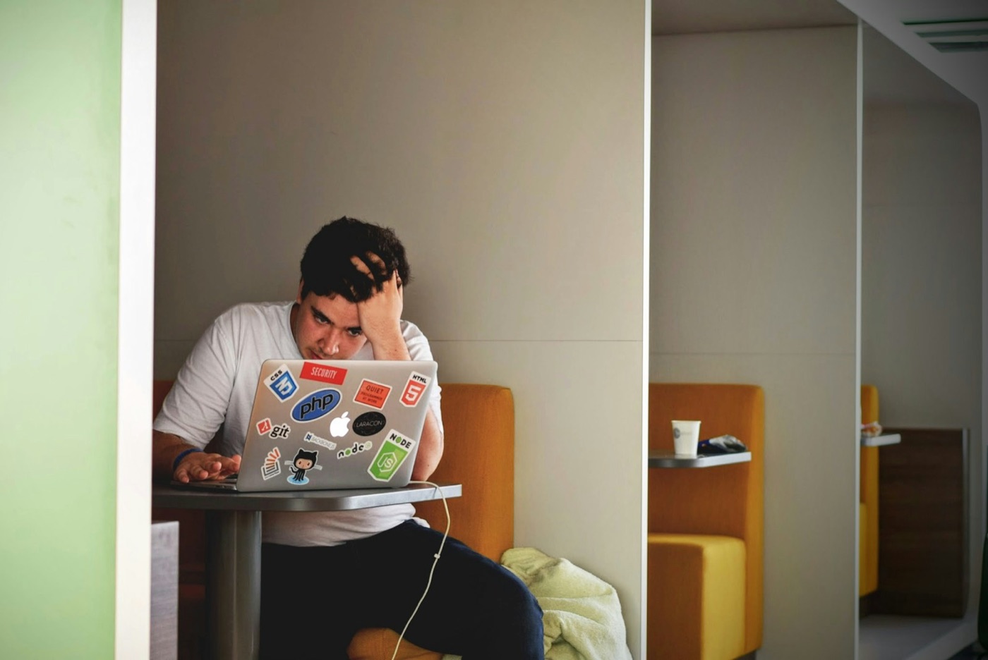 A frustrated applicant slumped over his laptop